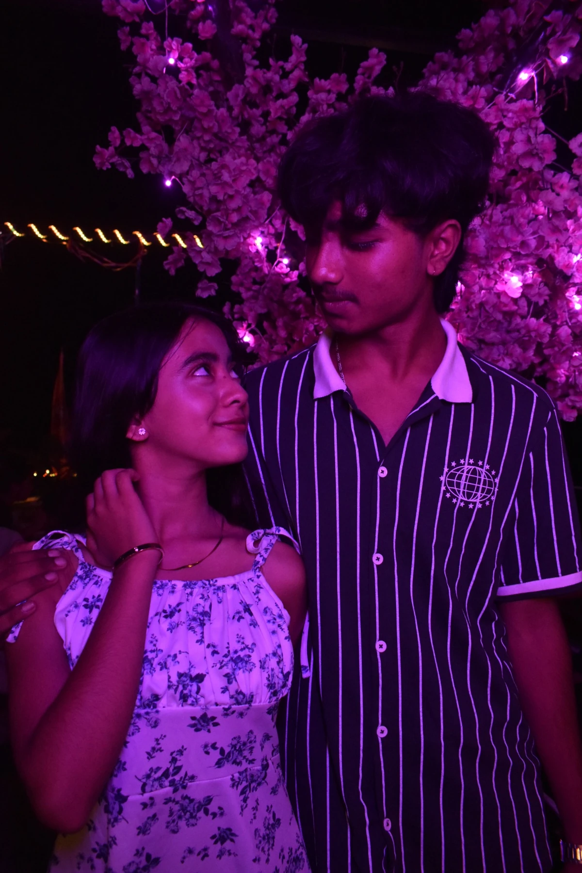 Couple portrait under violet lights